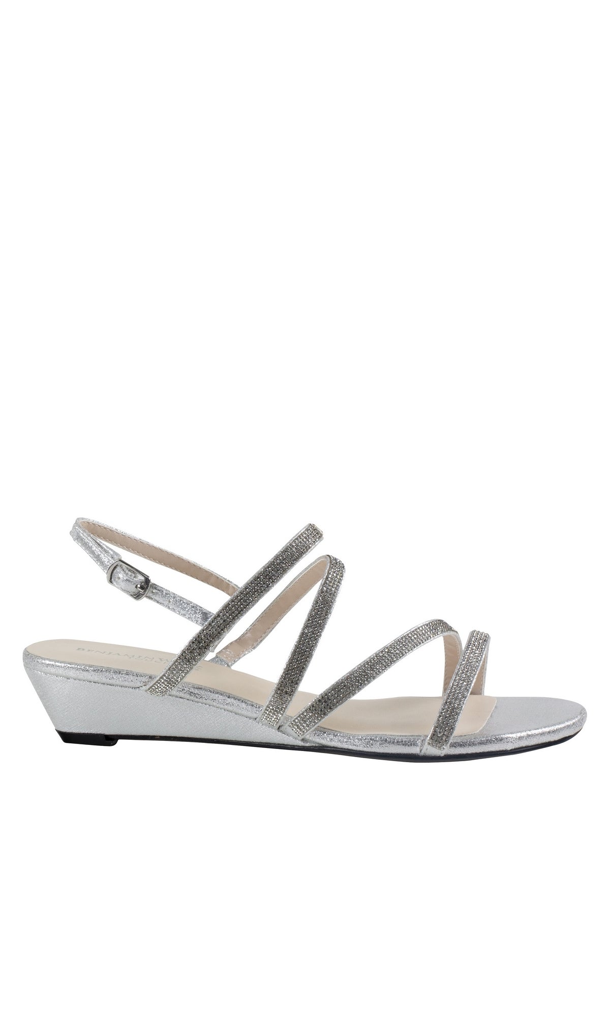 The Jodi Rhinestone Silver Prom Sandals by Touch Ups 4595 feature a sleek, silver strappy design with a low wedge heel and adjustable ankle strap, perfect for adding elegance to any special occasion. Displayed on a white background.